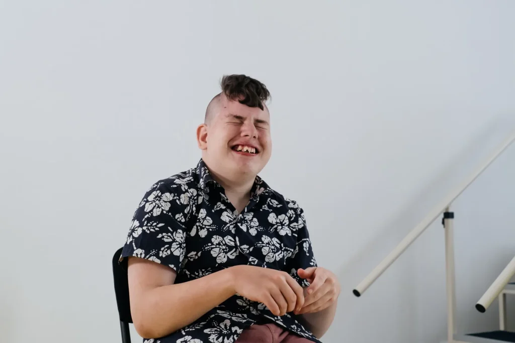 Happy disabled boy laughing