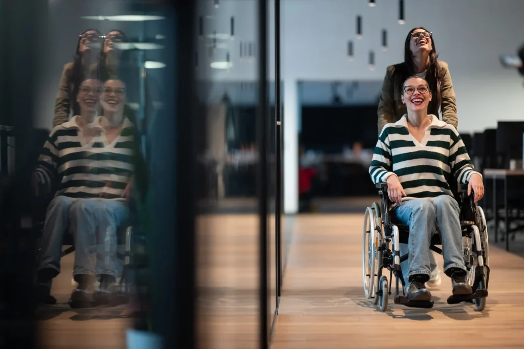 Support worker pushing disabled woman in wheelchair
